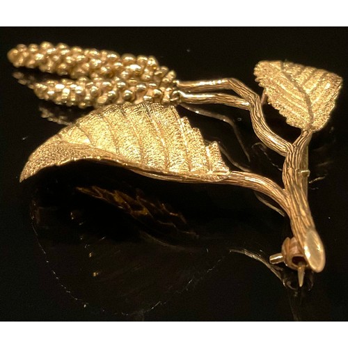 1331 - A 9ct gold hazel brooch, formed as a delicate branch bearing leaves and catkins, 8cm long, 11.7g