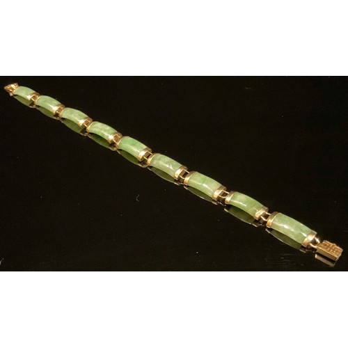 1343 - A Chinese 14ct gold mounted green jade bracelet, set with nine curved rectangular panels, 19cm overa... 