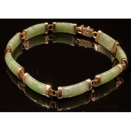 1343 - A Chinese 14ct gold mounted green jade bracelet, set with nine curved rectangular panels, 19cm overa... 