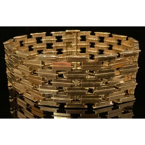 1336 - A 9ct gold pierced brick link bracelet, each textured panel divided by burnished strap, 19cm long, a... 