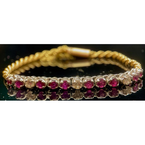 1451 - A unusual ruby and diamond bracelet, the three brilliant cut diamonds flanked and divided by 10 rubi... 