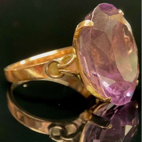 1397 - A large amethyst solitaire ring, stamped '14K' for 14ct gold, the oval facet cut stone claw set, rin... 