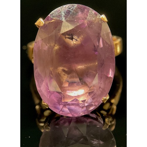 1397 - A large amethyst solitaire ring, stamped '14K' for 14ct gold, the oval facet cut stone claw set, rin... 