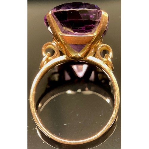 1397 - A large amethyst solitaire ring, stamped '14K' for 14ct gold, the oval facet cut stone claw set, rin... 