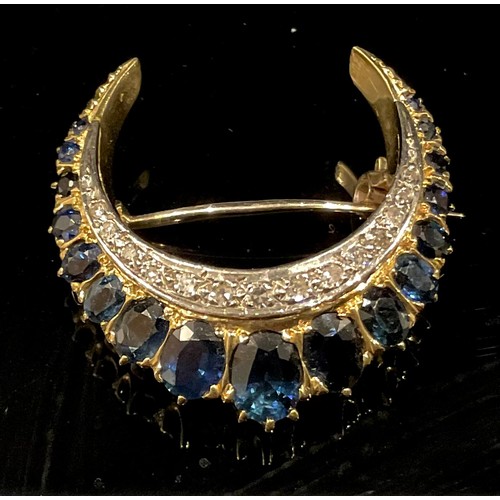 1440 - A sapphire and diamond 18ct gold crescent brooch, the brilliant cut diamonds set within a graduated ... 