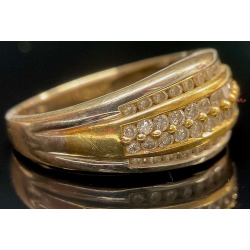 1487 - an 18ct white and yellow gold ring, the raised central band set with 28 diamonds in two rows, within... 