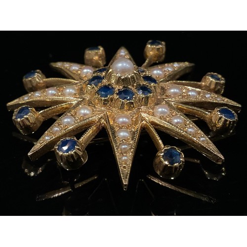 1442 - A sapphire, seed peal and 9ct gold eight pointed star brooch, each point set with graduated seed pea... 