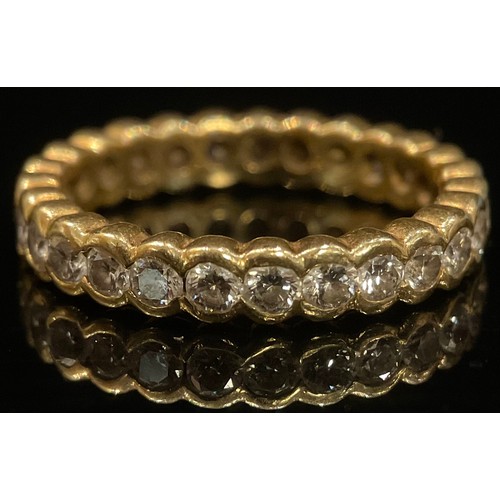 1352 - A diamond and 18ct gold eternity ring, 27 bezel set stones, size O/P