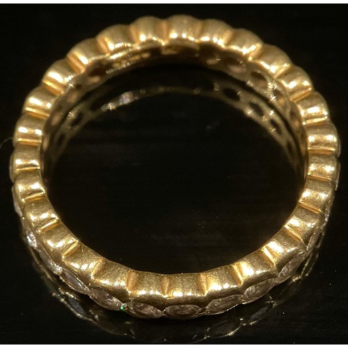 1352 - A diamond and 18ct gold eternity ring, 27 bezel set stones, size O/P