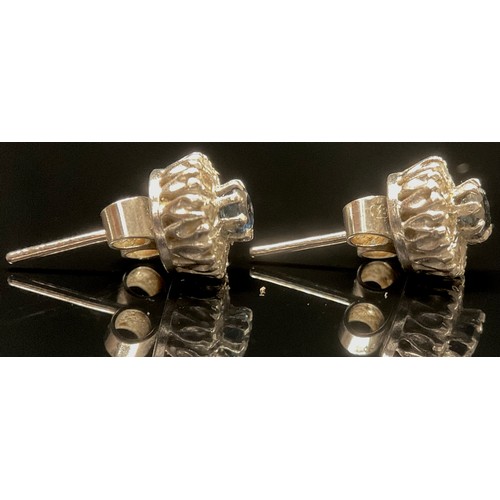 1437 - A pair of sapphire and diamond cluster ear studs, the raised central claw set sapphire within 8 roun... 