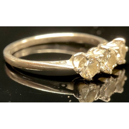 1447 - A three stone diamond and platinum ring, claw set brilliant cut stones, each stone approximately 0.2... 