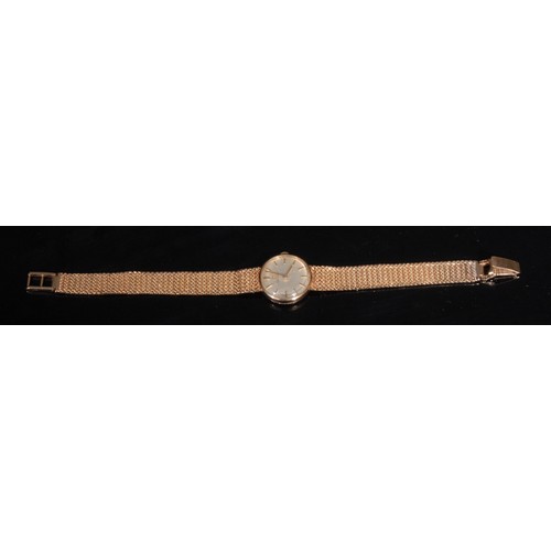 1281 - A 9ct gold ladies Omega wristwatch, the 2cm circular champagne dial with baton numeral markers, mesh... 