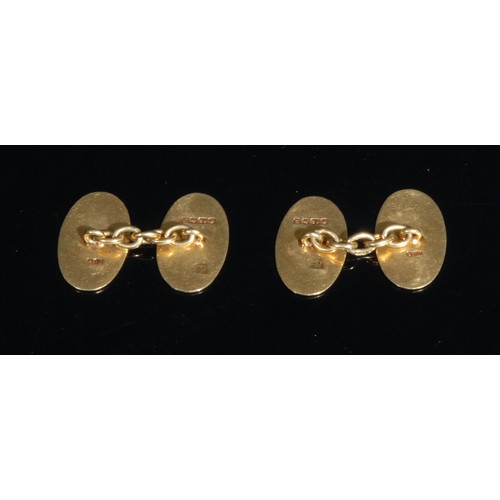 1429 - A pair of George V 18ct gold gentleman's cuff links, each oval engraved with a family crest rampant ... 