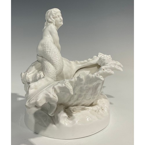 234 - A Derby Crown Porcelain Company table centre, as a mermaid perched atop a conch shell, with sprays o... 