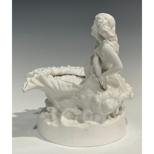 234 - A Derby Crown Porcelain Company table centre, as a mermaid perched atop a conch shell, with sprays o... 