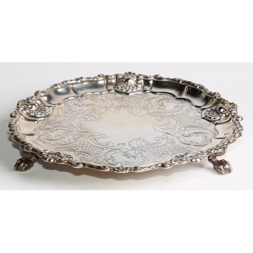 944 - A George III silver waiter, moulded and cast border, engraved field, three claw and ball feet, 24cm,... 