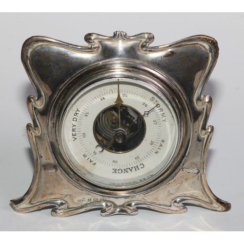 1164 - An Edwardian silver easel desk thermometer, scroll border, 15.5cm high, London 1906; an Art Nouveau ... 