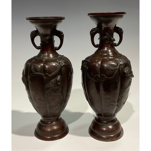 448 - A near pair of Japanese bronze lobed ovoid vases, the everted necks with elephant mask handles, dome... 