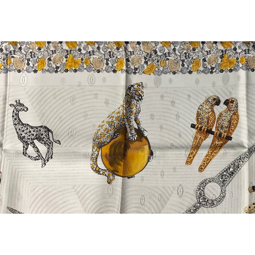 2439 - A Cartier square silk scarf, printed with jeweled birds and African animals, original box and tissue... 