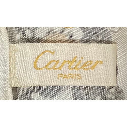 2439 - A Cartier square silk scarf, printed with jeweled birds and African animals, original box and tissue... 