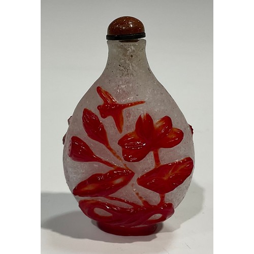 401 - A Chinese Peking glass ovoid snuff bottle, decorated in red overlay with fantail fish against a snow... 