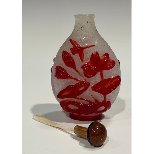 401 - A Chinese Peking glass ovoid snuff bottle, decorated in red overlay with fantail fish against a snow... 