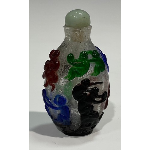 401 - A Chinese Peking glass ovoid snuff bottle, decorated in red overlay with fantail fish against a snow... 