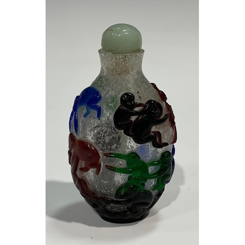 401 - A Chinese Peking glass ovoid snuff bottle, decorated in red overlay with fantail fish against a snow... 