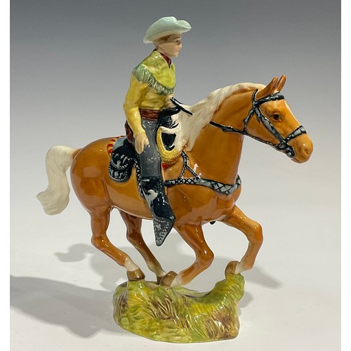 25 - A Beswick model of a Canadian Mounted Cowboy on a galloping Palomino horse, number 1377, 22.5cm, pri... 