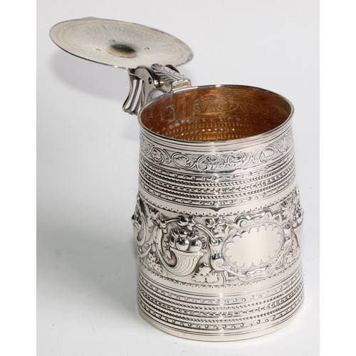 940 - A George III silver spreading cylindrical tankard, hinged slightly domed cover, open-work thumbpiece... 