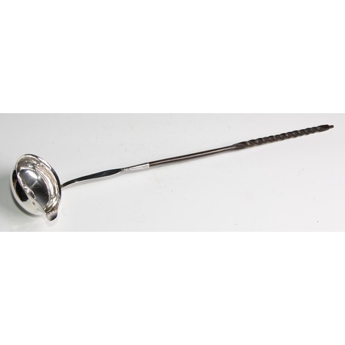 941 - A George III silver toddy ladle, inset with coin, twisted baleen handle, 39cm long, London 1788; a G... 