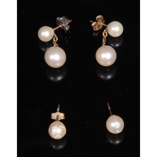 1348 - A composed suite of 9ct and 14ct cultured pearl jewellery, comprising a 14k gold ring, size Q, 3.4g;... 