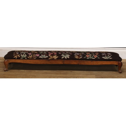 2295 - A Victorian walnut sofa-length serpentine footstool or hearth stool, shaped apron carved with scroll... 