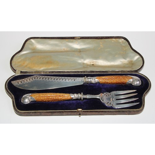 793 - A pair of late Victorian silver country house fish servers, pierced and wriggle-work engraved blades... 