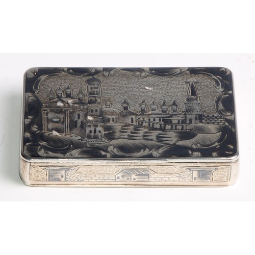 1046 - A Russian silver and niello rounded rectangular snuff box, profusely decorated with architectural vi... 