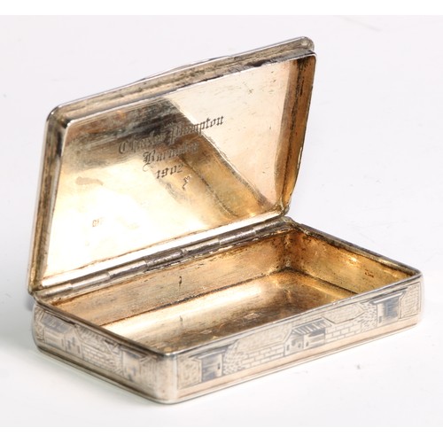 1046 - A Russian silver and niello rounded rectangular snuff box, profusely decorated with architectural vi... 