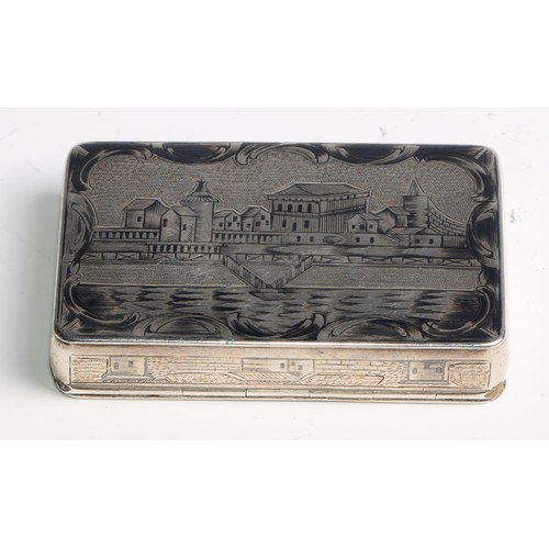 1046 - A Russian silver and niello rounded rectangular snuff box, profusely decorated with architectural vi... 