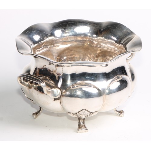 1049 - A Russian silver lobed circular two-handled bowl, scroll feet with stiff leaf bosses, 18cm wide, Mos... 