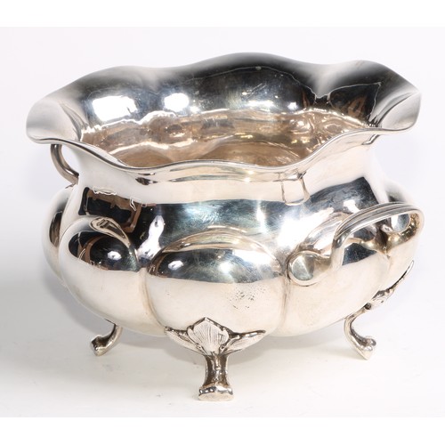 1049 - A Russian silver lobed circular two-handled bowl, scroll feet with stiff leaf bosses, 18cm wide, Mos... 