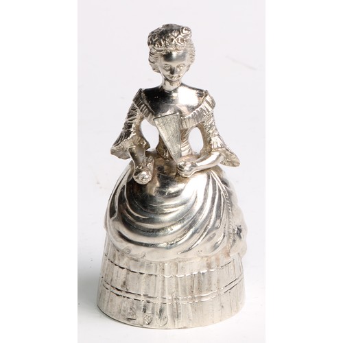 880 - A Continental silver novelty table bell, cast as a lady of title, elegantly dressed and holding a fa... 