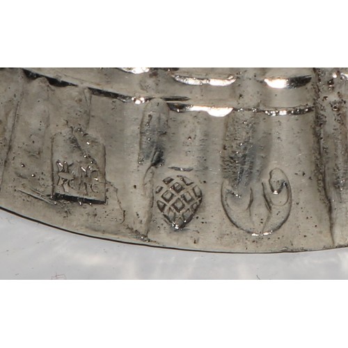 880 - A Continental silver novelty table bell, cast as a lady of title, elegantly dressed and holding a fa... 