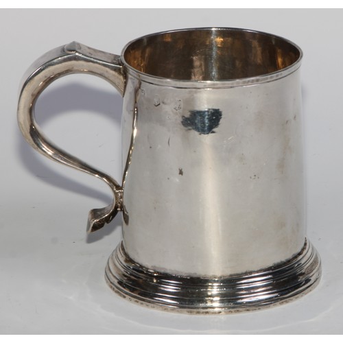 901 - A George II silver cylindrical mug, quite plain, scroll handle with whistle terminal, skirted base, ... 