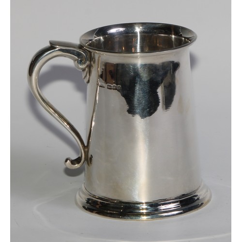 1200 - Asprey & Co - a George V silver pint mug, of plain George III design, flared rim, scroll-capped hand... 