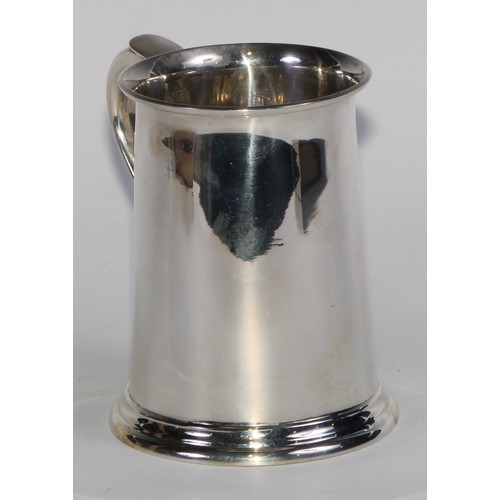 1200 - Asprey & Co - a George V silver pint mug, of plain George III design, flared rim, scroll-capped hand... 