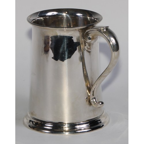 1200 - Asprey & Co - a George V silver pint mug, of plain George III design, flared rim, scroll-capped hand... 