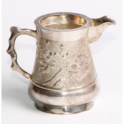 863 - A Chinese silver cream jug, chased with blossoming prunus on a textured ground, 8.5cm high, maker AE... 