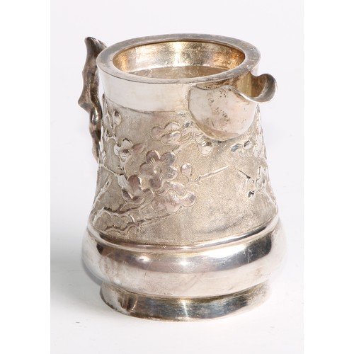 863 - A Chinese silver cream jug, chased with blossoming prunus on a textured ground, 8.5cm high, maker AE... 