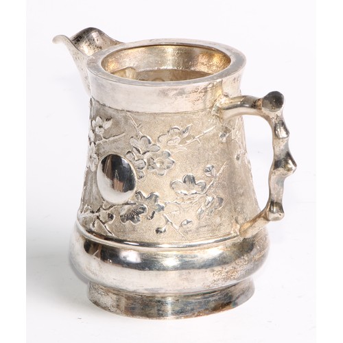 863 - A Chinese silver cream jug, chased with blossoming prunus on a textured ground, 8.5cm high, maker AE... 