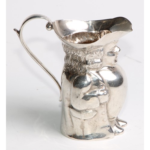 963 - A George V silver novelty cream pitcher, as a toby jug, modelled after a Staffordshire pottery model... 