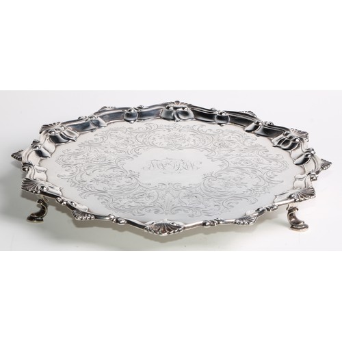 1151 - An early George III silver shaped octagonal salver, shell, C, and S-scroll border, the field engrave... 